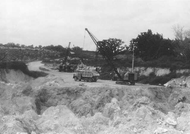 Phosphate mining with trucks and cranes in the mid-twentieth century